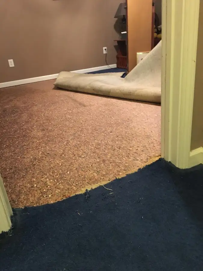 Carpet pad removal revealing water damage during Drying & Dehumidification in Earlimart